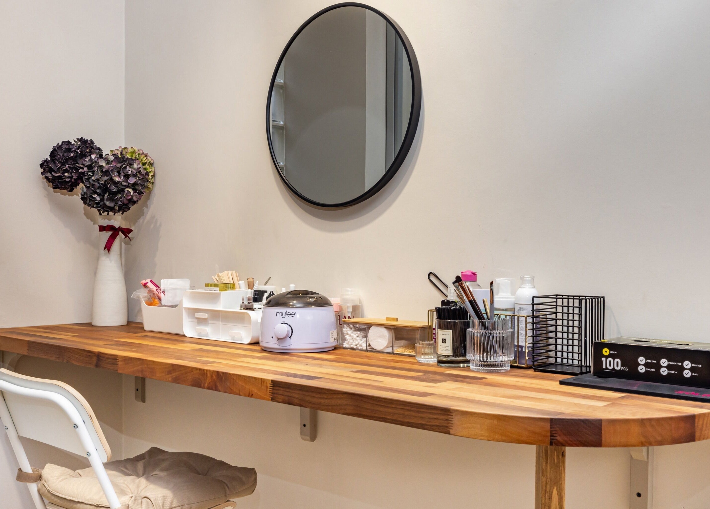 Chic nail station at Show Me Your Nails, London, England, GB, featuring a wooden desk and beauty products.