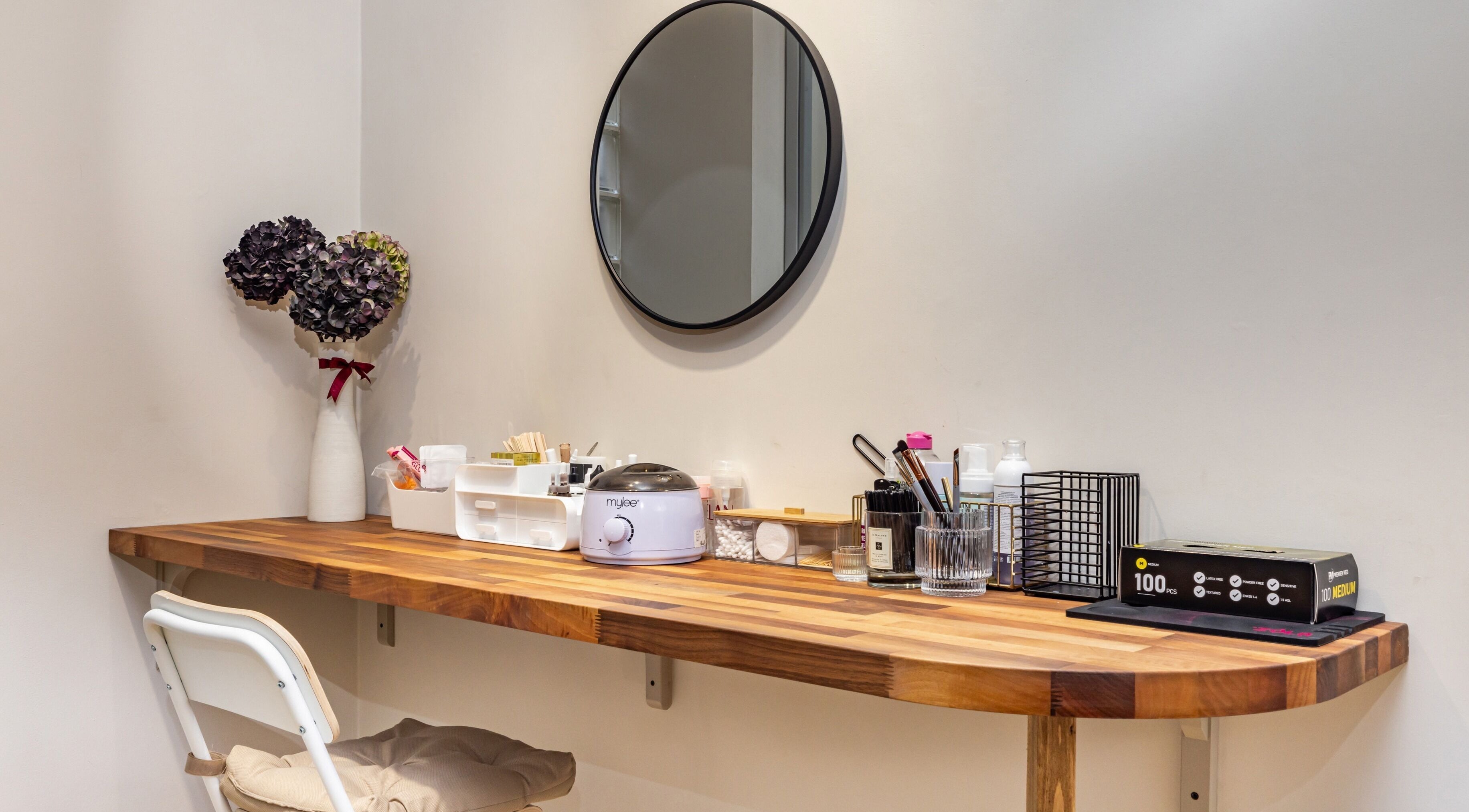 Chic nail station at Show Me Your Nails, London, England, GB, featuring a wooden desk and beauty products.