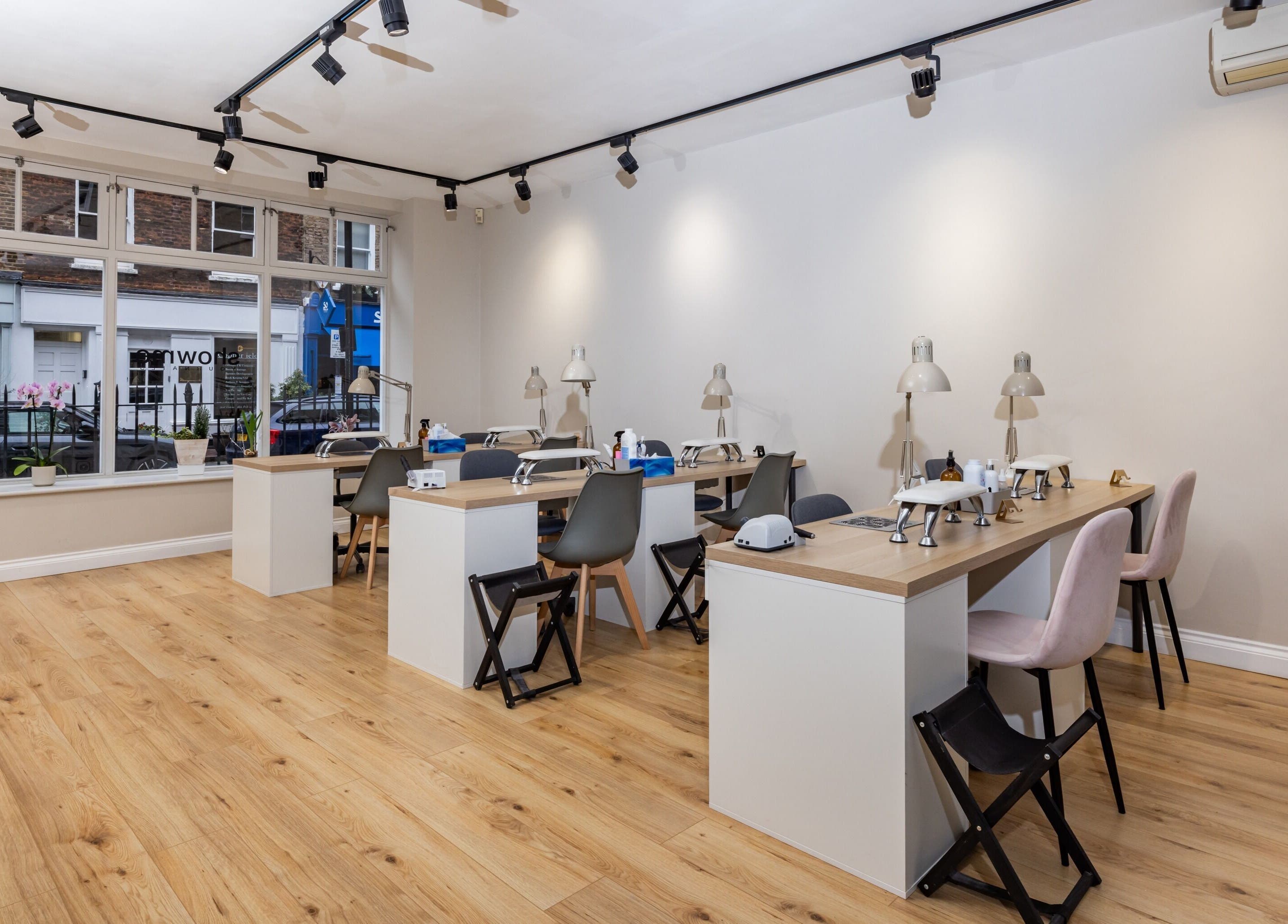 Interior of Show Me Your Nails in London, England, GB featuring modern manicure stations and bright decor.