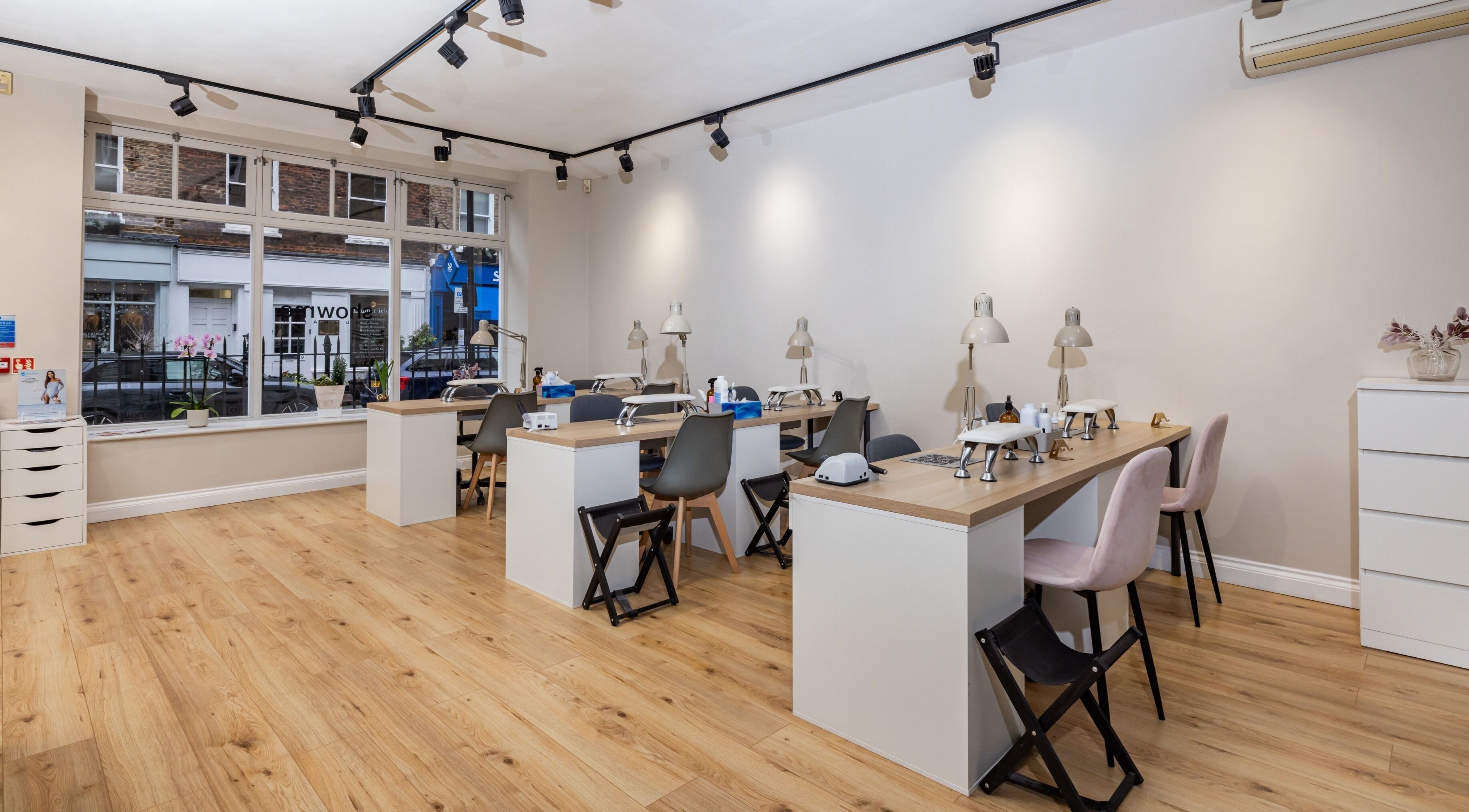 Interior of Show Me Your Nails in London, England, GB featuring modern manicure stations and bright decor.