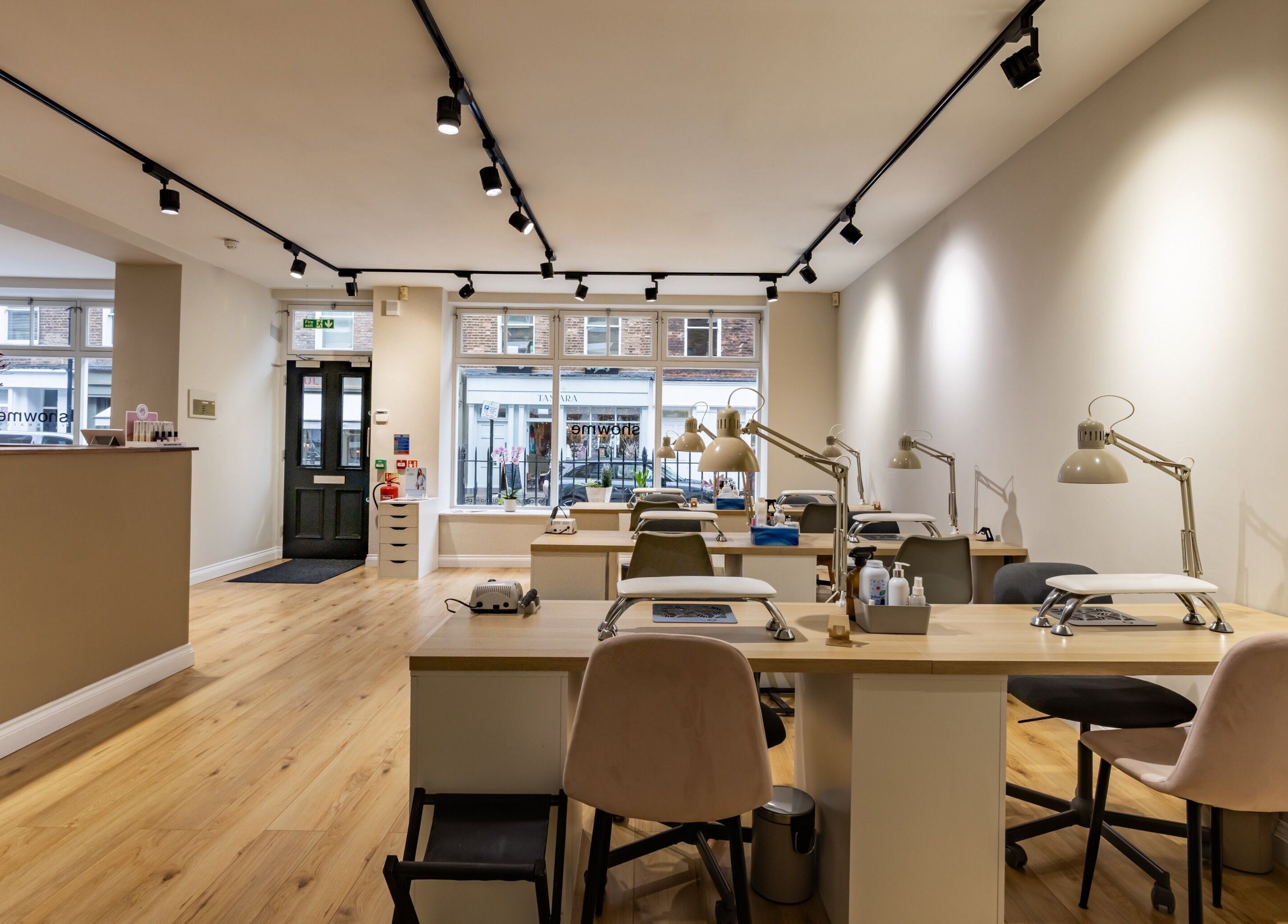 Stylish nail salon interior at Show Me Your Nails, London, England, GB, featuring modern manicure stations.