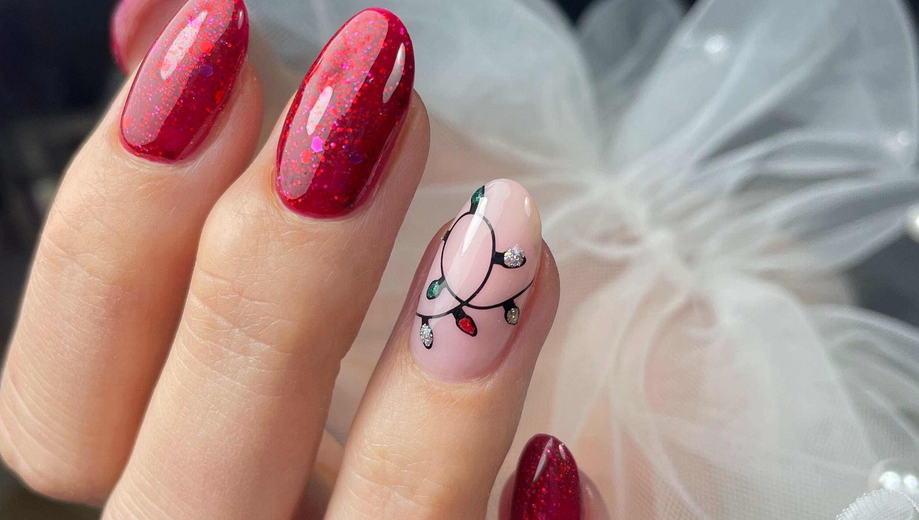 Festive red and light bulb nail art at Lady Nails Justyna, Cork, County Cork, IE.