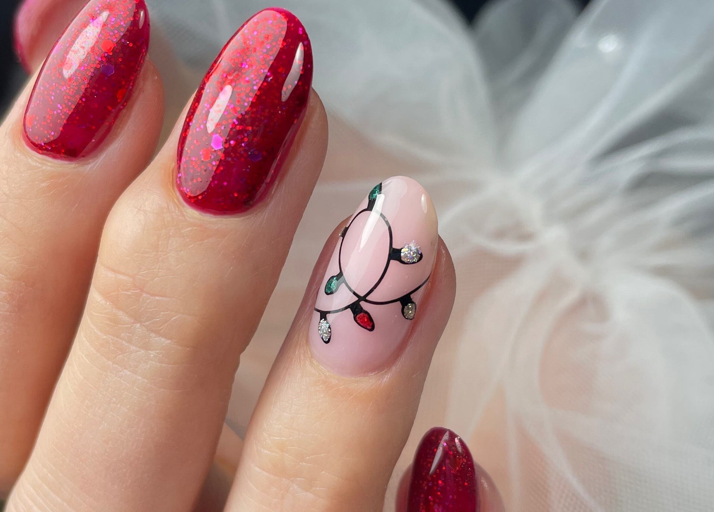 Festive red and light bulb nail art at Lady Nails Justyna, Cork, County Cork, IE.