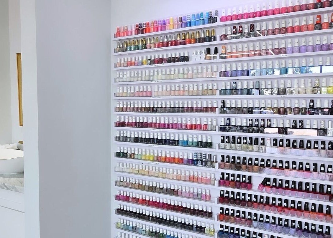 Vibrant nail polish wall at Plush Nail Salon Ii in Glenview, Illinois, US showcasing diverse color options.