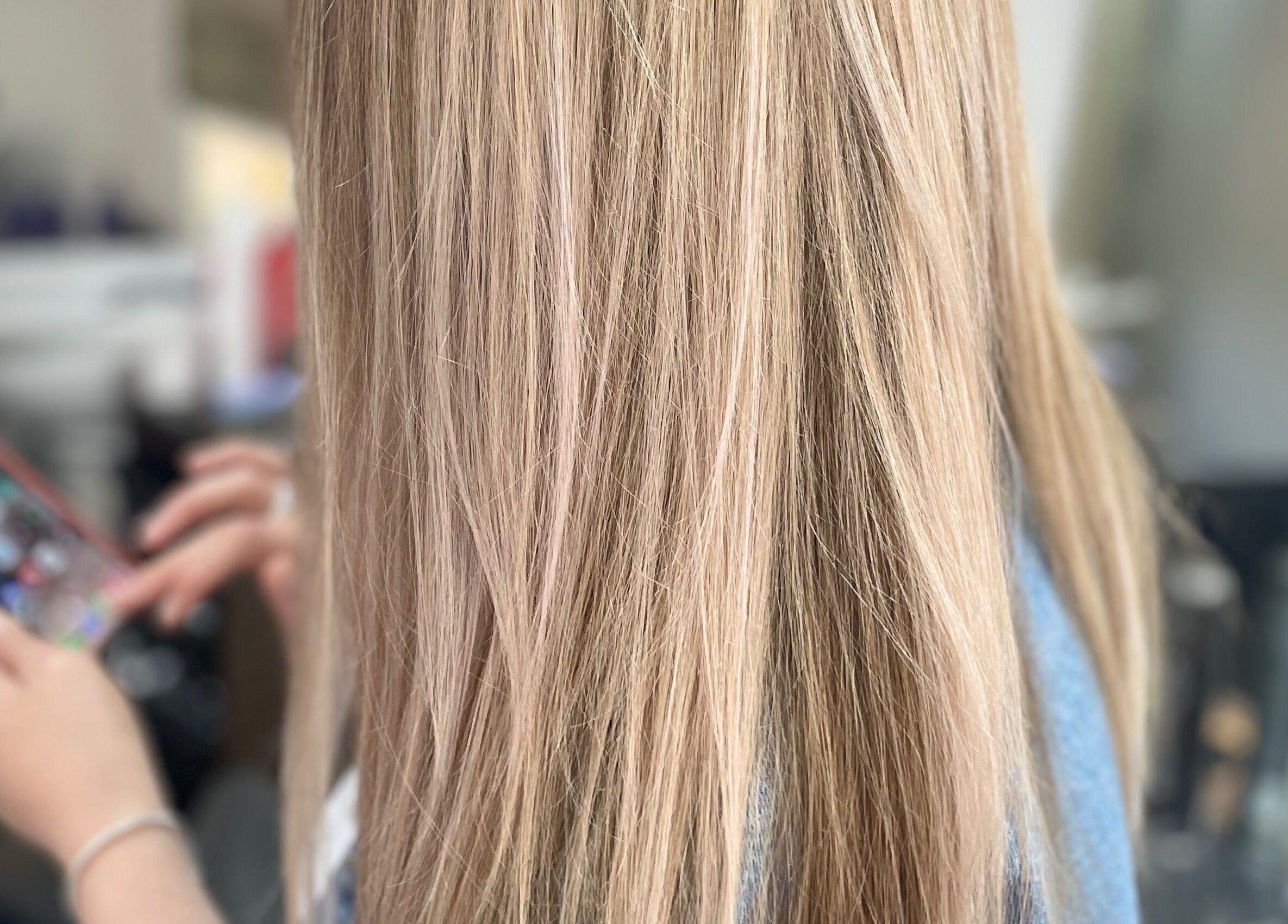 Close-up of long blonde hair in salon at Beauty From The Heart, Belper, England, GB.