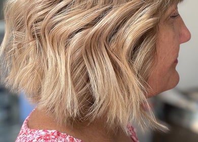 Close-up of wavy blonde hairstyle at Beauty From The Heart, Belper, England, GB.
