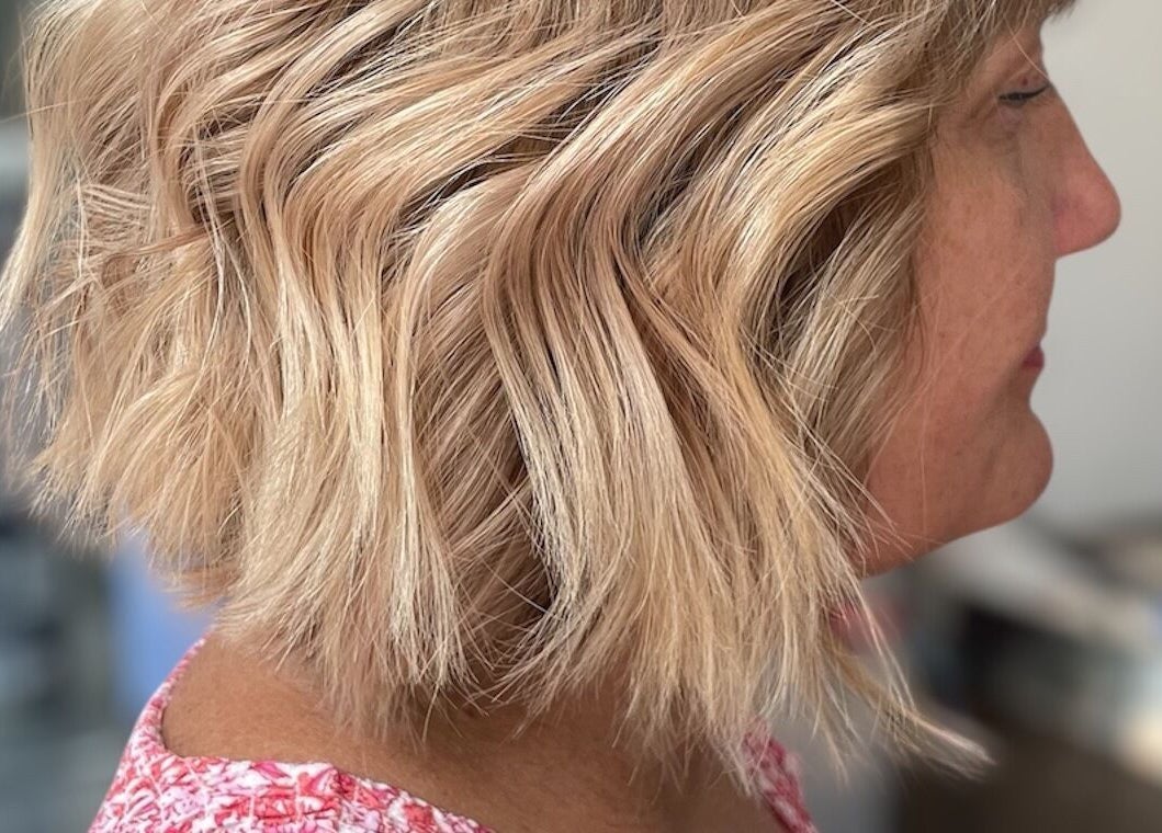 Close-up of wavy blonde hairstyle at Beauty From The Heart, Belper, England, GB.