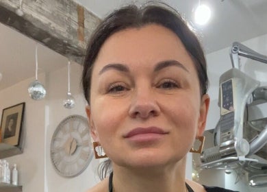 Welcoming stylist at Beauty From The Heart, Belper, England, GB, with modern interior and beauty products.