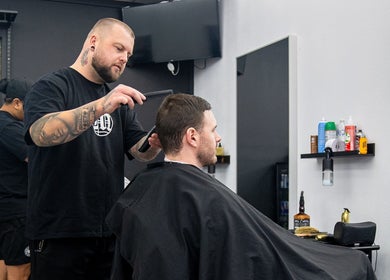 Barber styling hair at Crown Barbershop Blacktown, Blacktown, New South Wales, AU.