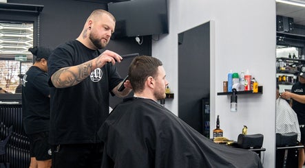 Barber styling hair at Crown Barbershop Blacktown, Blacktown, New South Wales, AU.