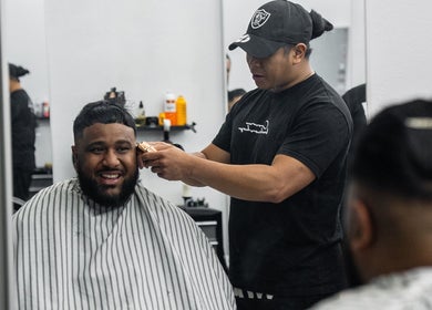 Barber styling a client's hair at Crown Barbershop Blacktown, New South Wales, AU.