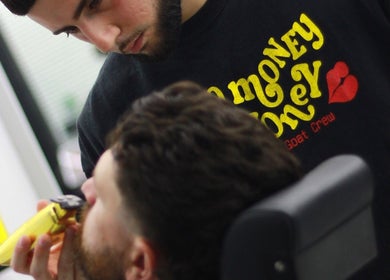 Barber trimming beard with clipper at Crown Barbershop Blacktown, New South Wales, AU.