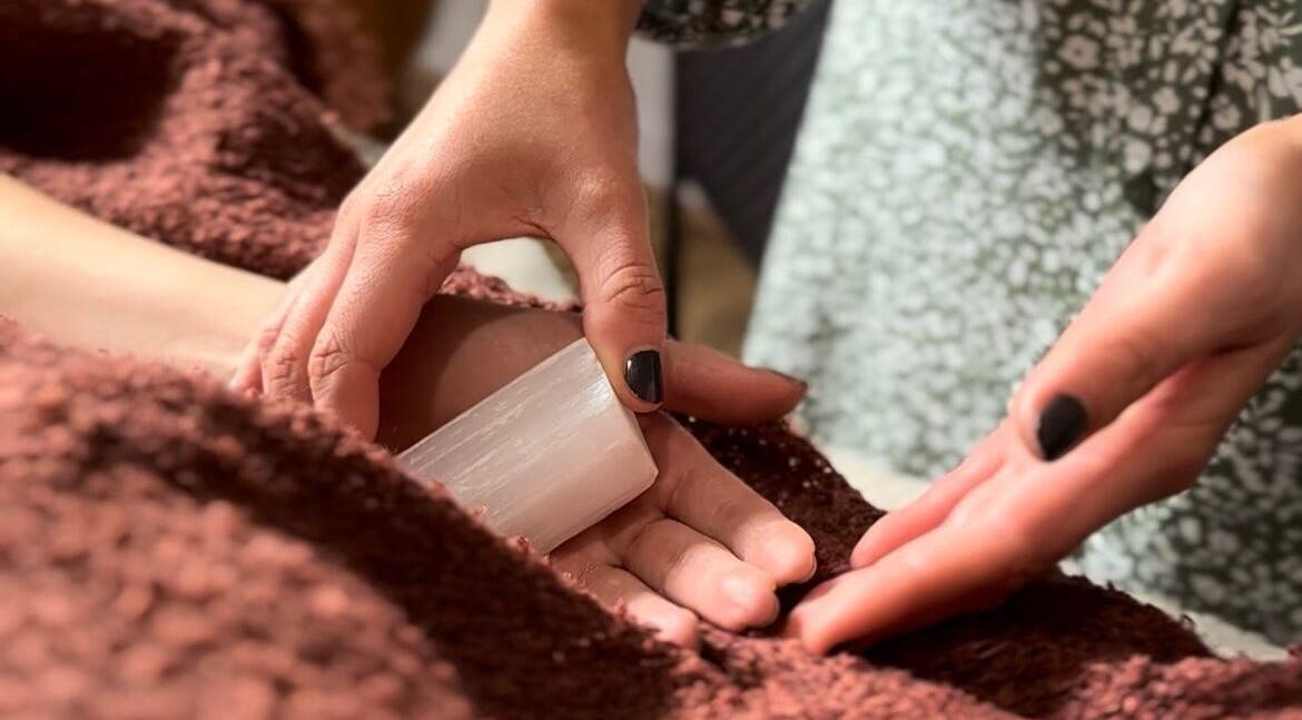 Hands using healing crystals at Smudge Studio, Limerick, County Limerick, IE for a wellness ritual.