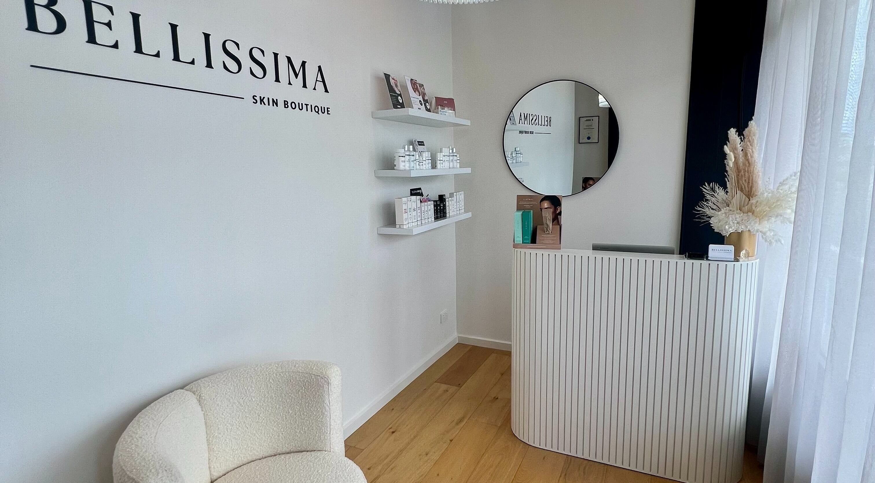 Reception area of Bellissima Skin Boutique, Melbourne, Victoria, AU with modern decor and skincare products.
