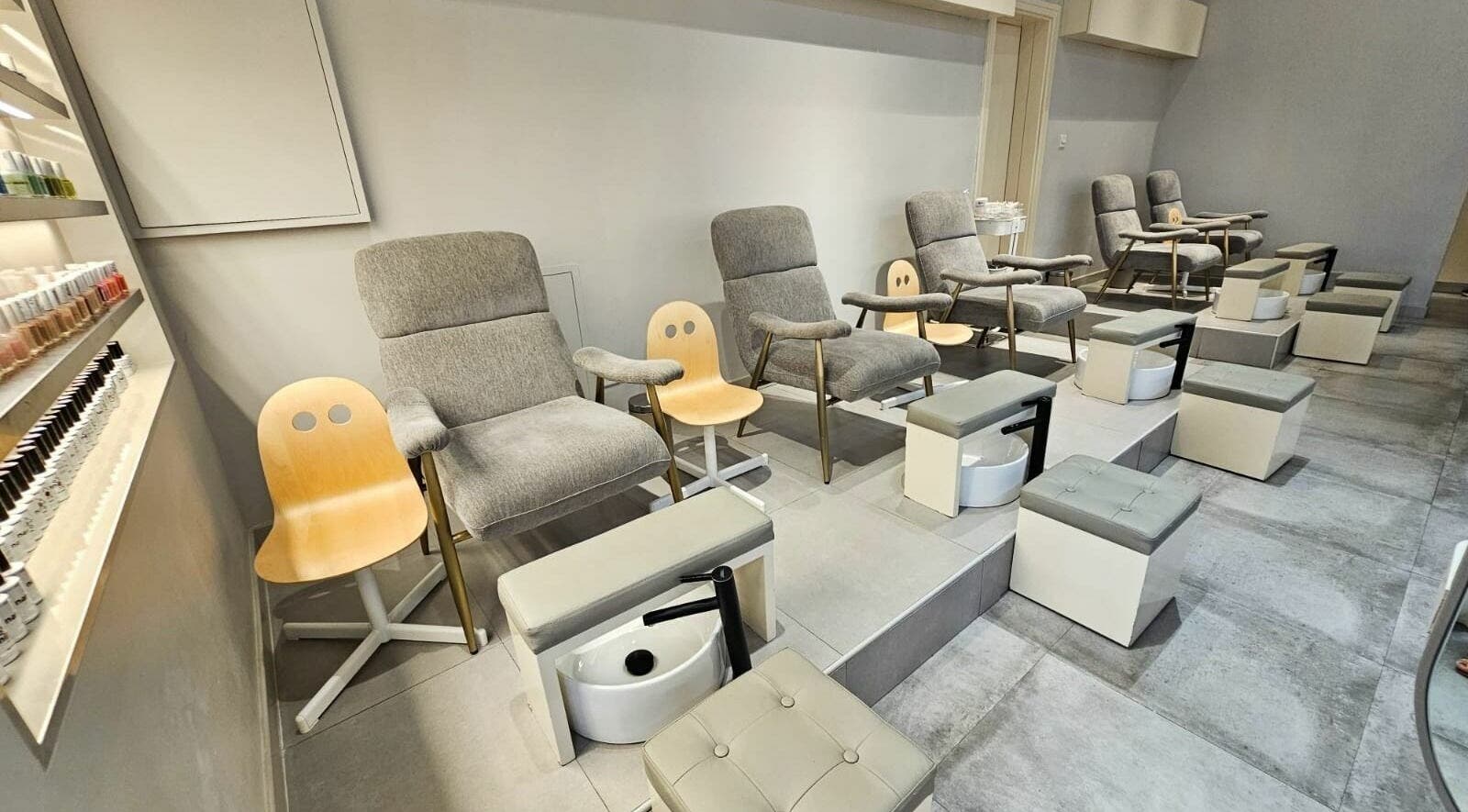 Cozy nail salon chairs at Shade Beauty Center UAE in Sharjah, AE offering a relaxing pedicure experience.