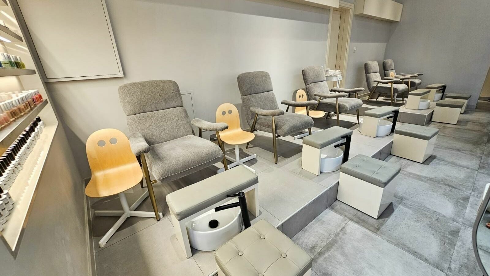 Cozy nail salon chairs at Shade Beauty Center UAE in Sharjah, AE offering a relaxing pedicure experience.