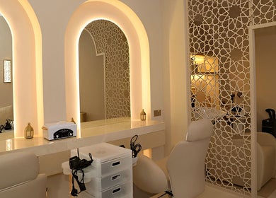 Luxurious interior of Shade Spa in Sharjah, AE, featuring elegant mirrors and plush seating.