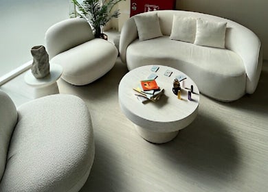 Comfortable seating at Shade Spa, Sharjah, AE, featuring modern sofas and a round table with decor.