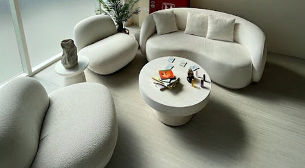Comfortable seating at Shade Spa, Sharjah, AE, featuring modern sofas and a round table with decor.