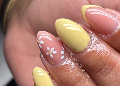 Stylish yellow and floral nail art by Polished in Berea, Kwazulu-natal, ZA, showcasing elegance and detail.