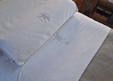 Luxury spa bed at AJM Aesthetics, Donegal Town, County Donegal, IE with plush white linens.