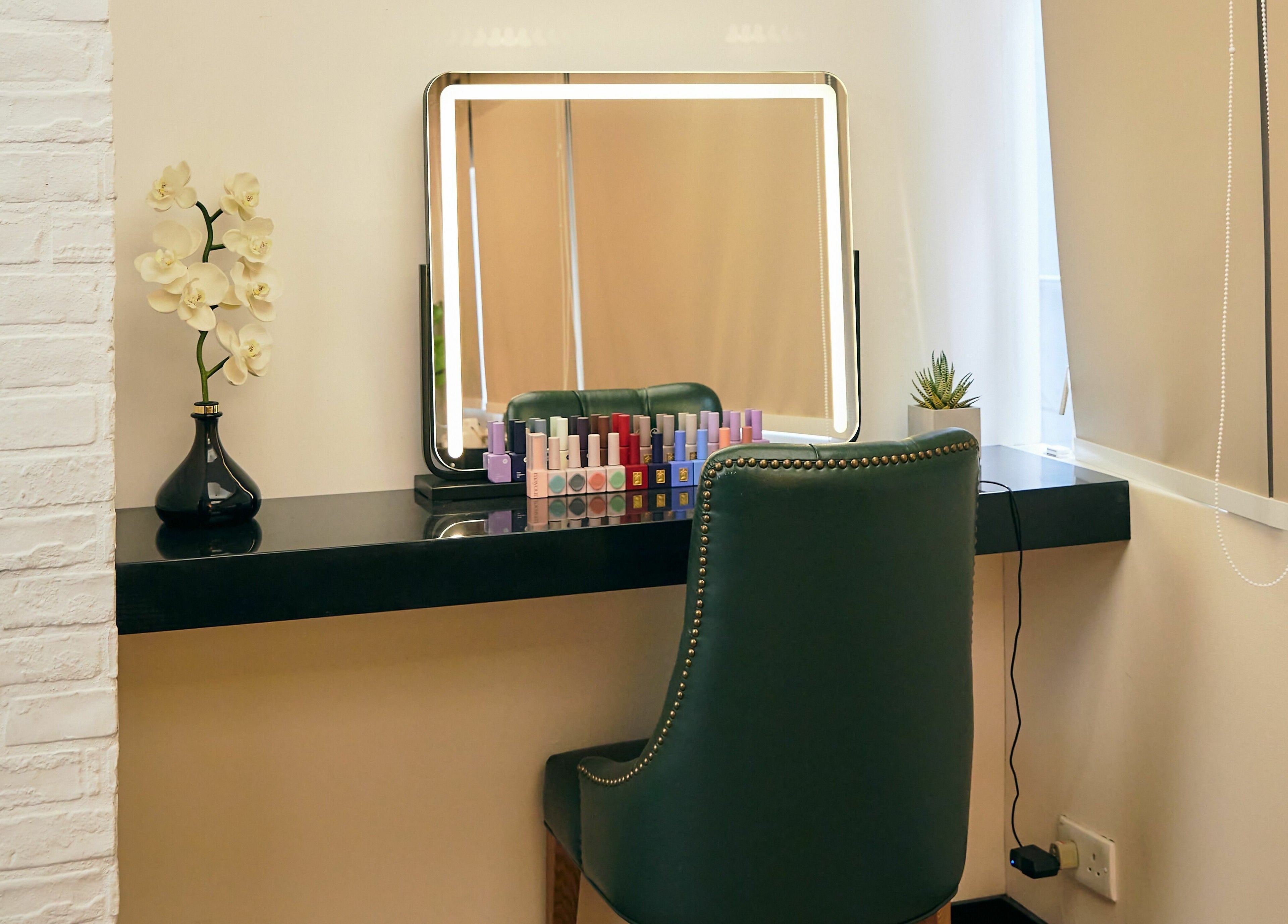 Stylish vanity at The Beau Barbershop & Hair Salon, Hong Kong Island, HK, with a mirror and flower decor.