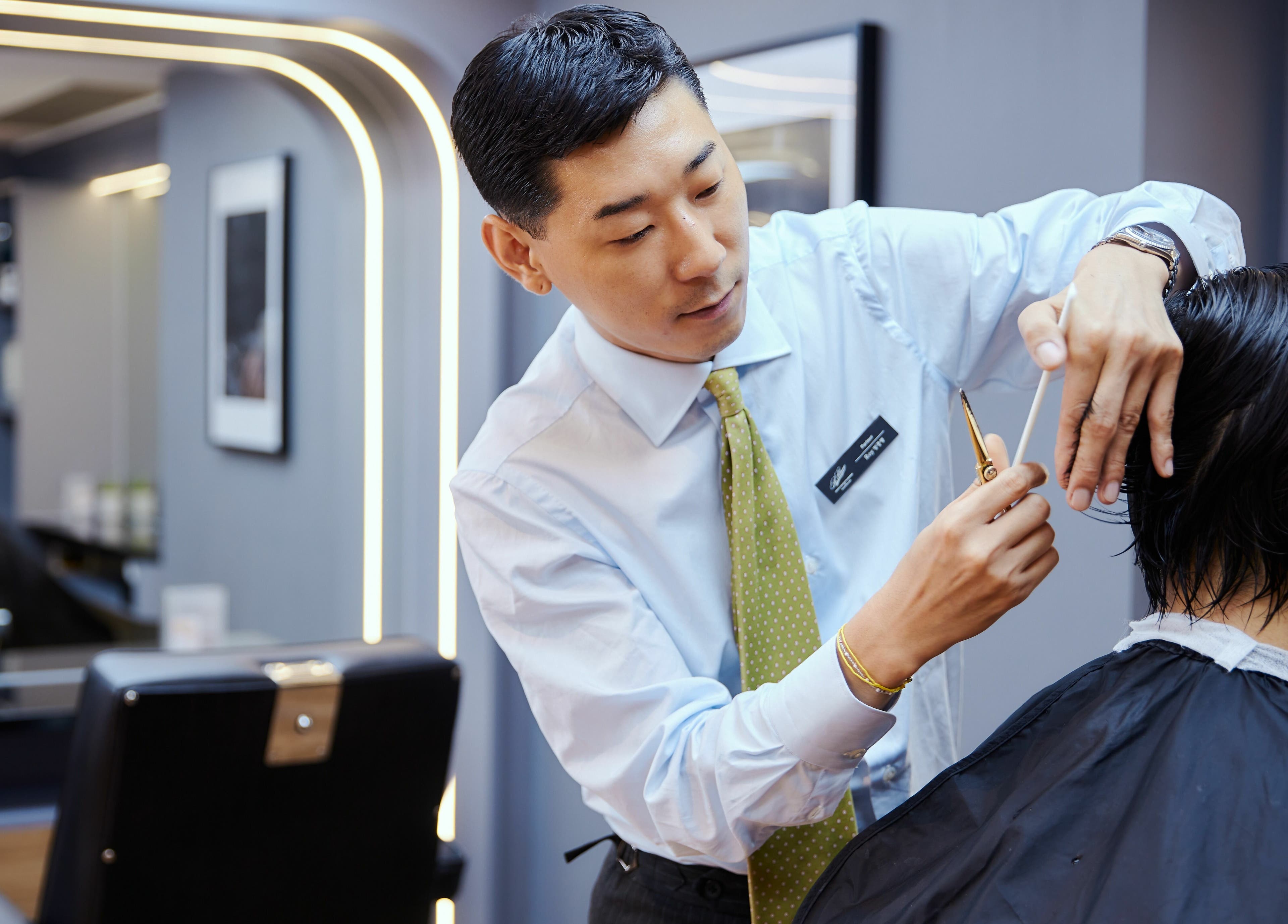 Expert stylist cutting hair at The Beau Barbershop & Hair Salon, Hong Kong Island, Hong Kong Island, HK.