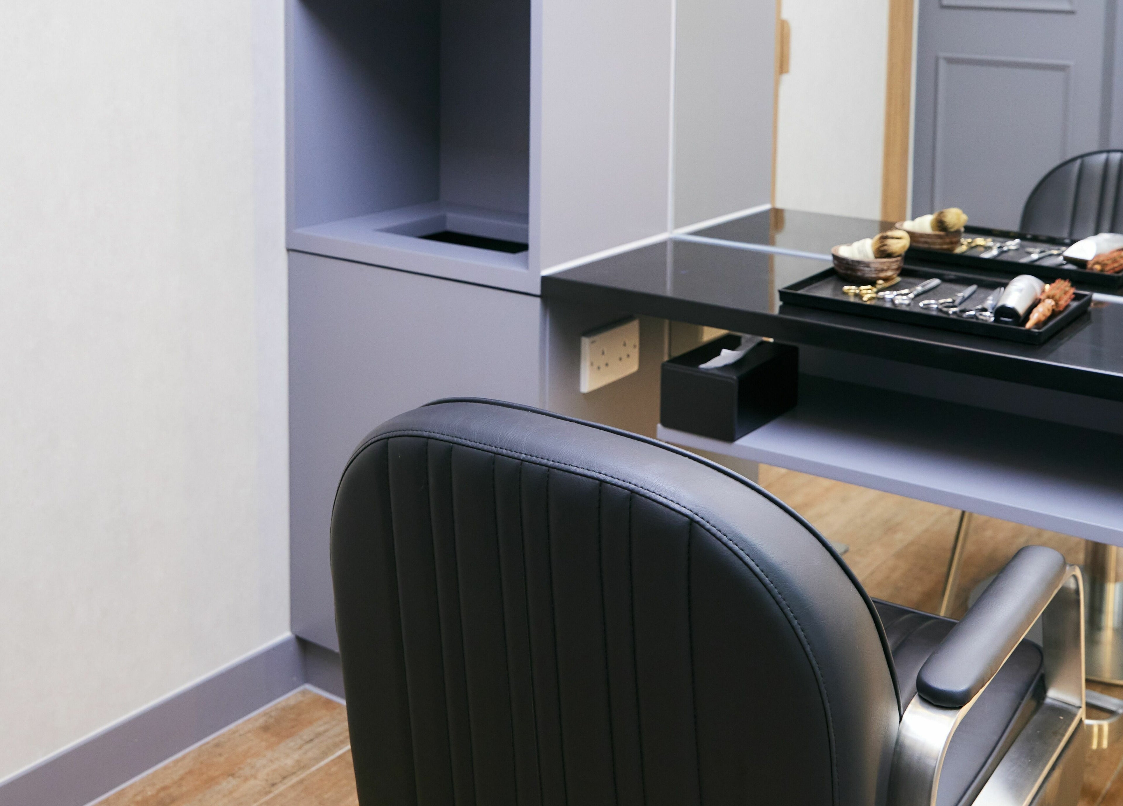 Modern barber chair at The Beau Barbershop & Hair Salon, Hong Kong Island, HK, featuring stylish décor.