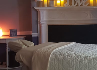 Effleurage Spa's tranquil massage room with soft lighting in Charles Town, West Virginia, US.