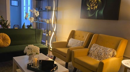 Effleurage Spa lounge with green sofa, yellow chairs, and floral decor in Charles Town, West Virginia, US.