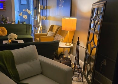 Effleurage Spa's cozy lounge with elegant seating, warm lighting, Charles Town, West Virginia, US.