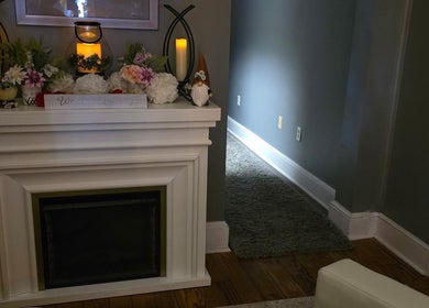 Cozy decorated mantel at Effleurage Spa, Charles Town, West Virginia, US, with candles and flowers.