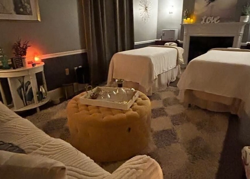 Effleurage Spa massage room with soft lighting and dual massage tables, Charles Town, West Virginia, US.