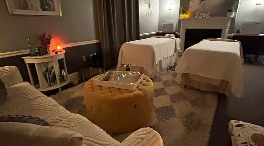 Effleurage Spa massage room with soft lighting and dual massage tables, Charles Town, West Virginia, US.