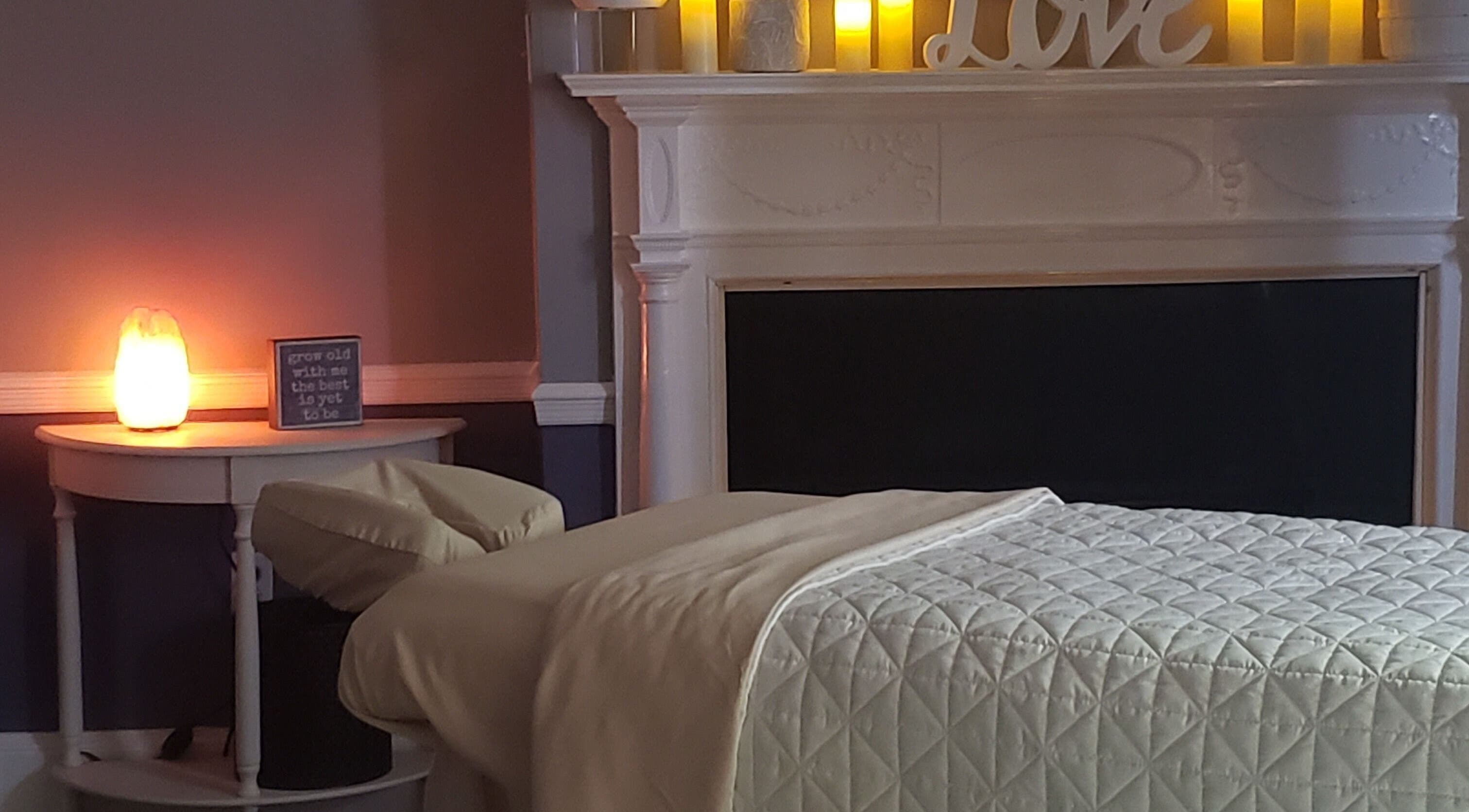 Relaxing massage room at Effleurage Spa, Charles Town, West Virginia, US with soft lighting and a cozy bed.