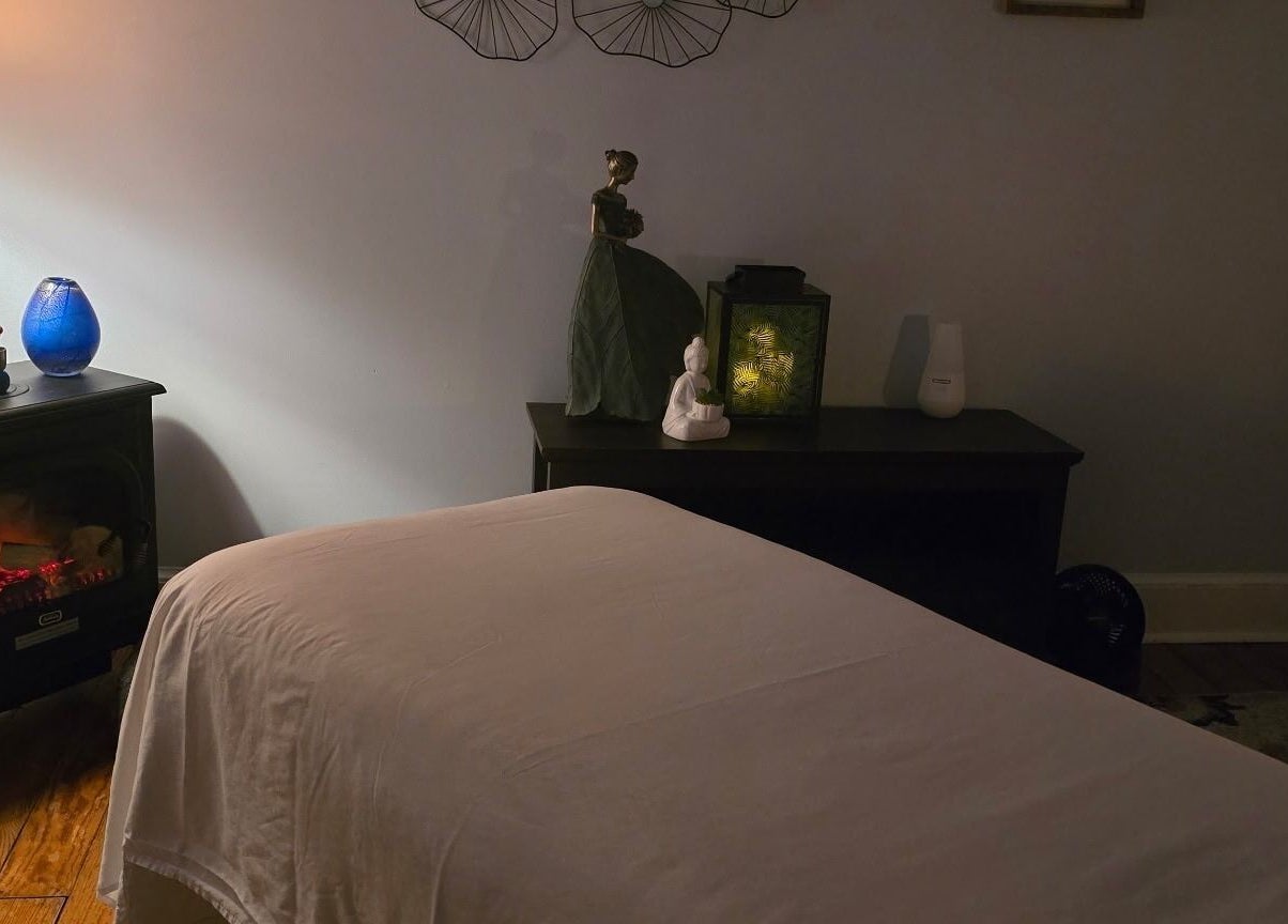 Serene massage room at Effleurage Spa in Charles Town, West Virginia, US with soft lighting and peaceful decor.