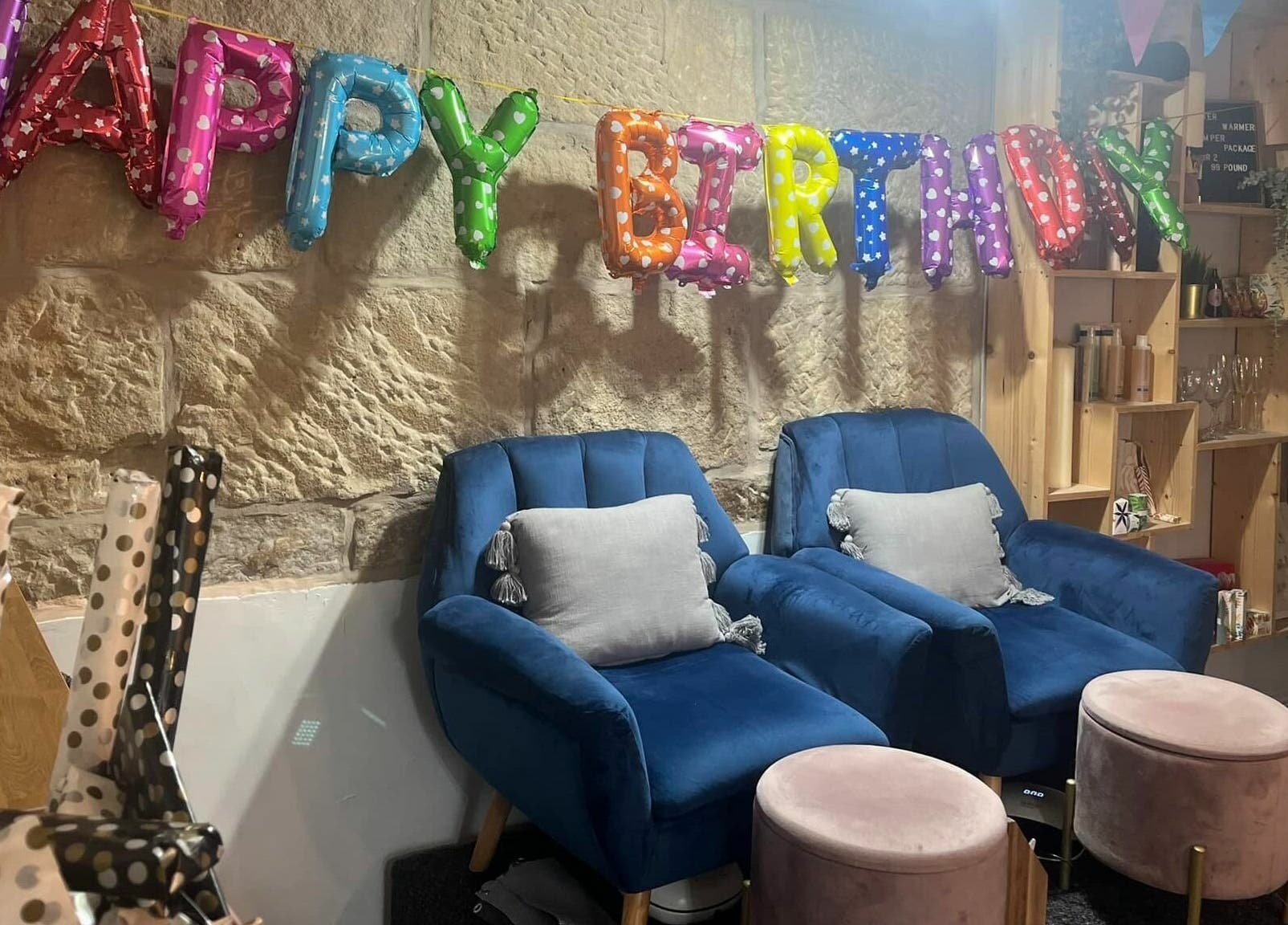 Cozy spa chairs and festive decor for a birthday celebration at Nail'd It, Todmorden, England, GB.