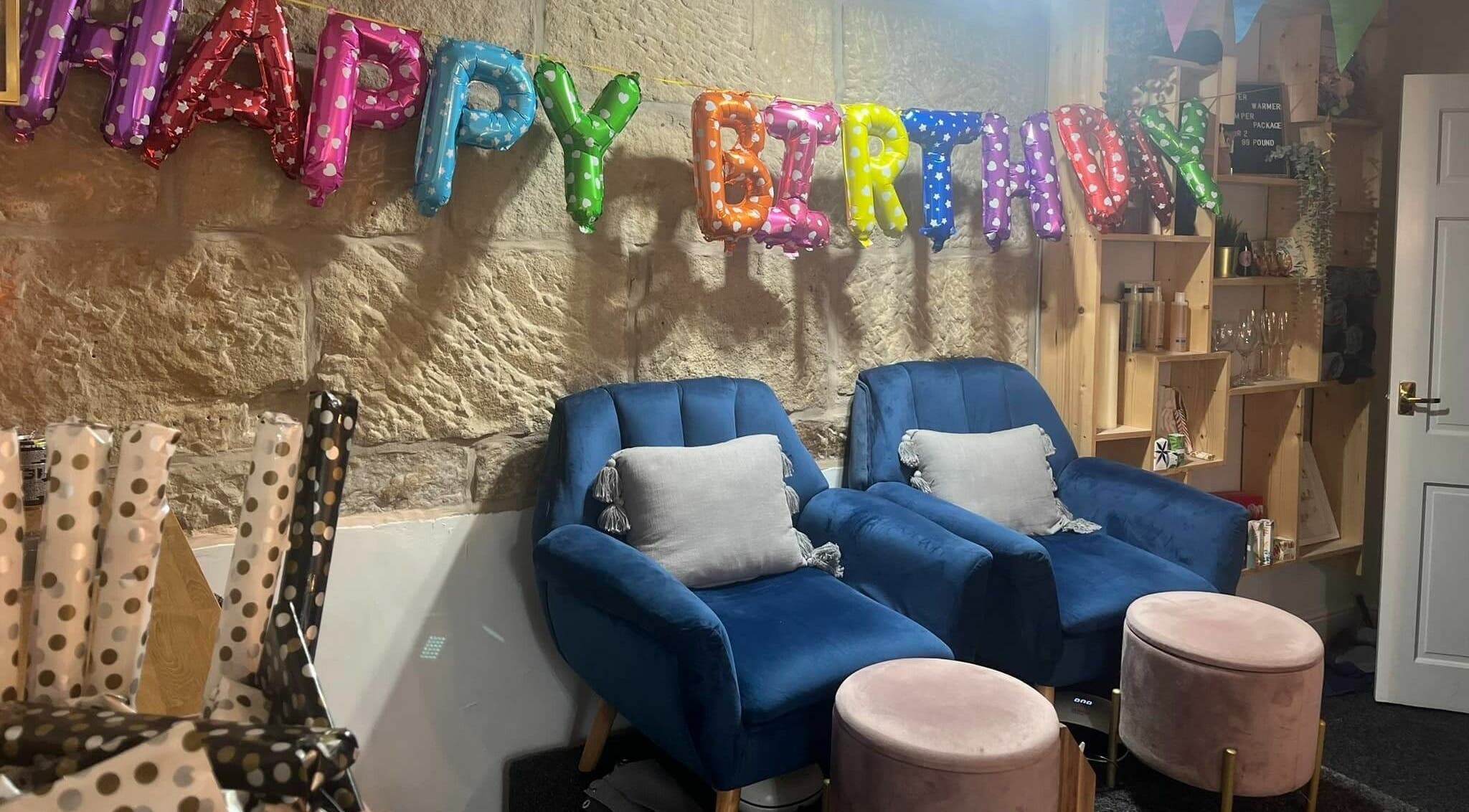 Cozy spa chairs and festive decor for a birthday celebration at Nail'd It, Todmorden, England, GB.