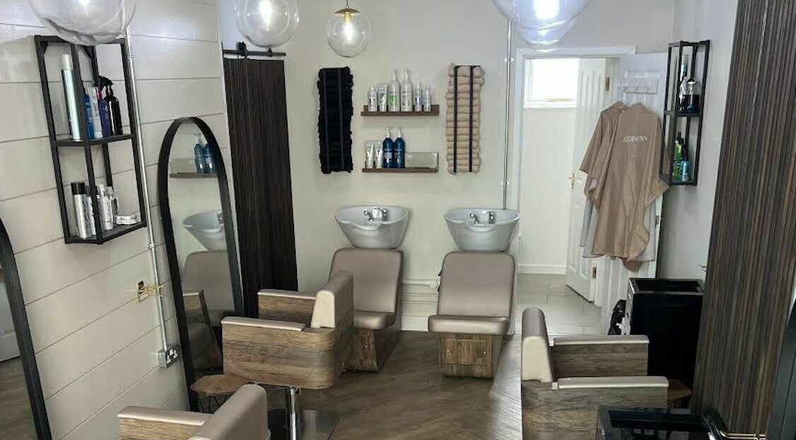 Modern salon interior at Addison’s, Bristol, England, GB with stylish seating and wash stations.