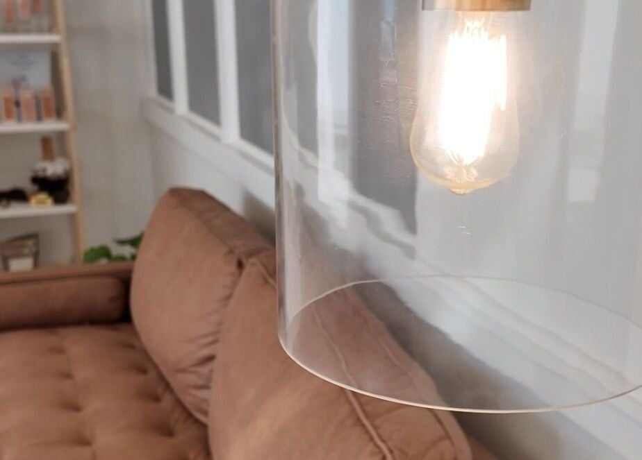 Warm, inviting lounge at Cyr Aesthetics, Petawawa, Ontario, CA, featuring a modern light fixture.