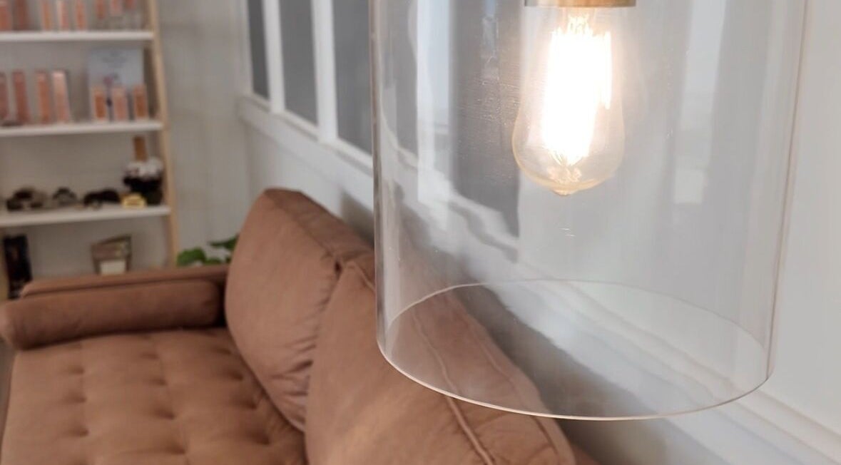 Warm, inviting lounge at Cyr Aesthetics, Petawawa, Ontario, CA, featuring a modern light fixture.