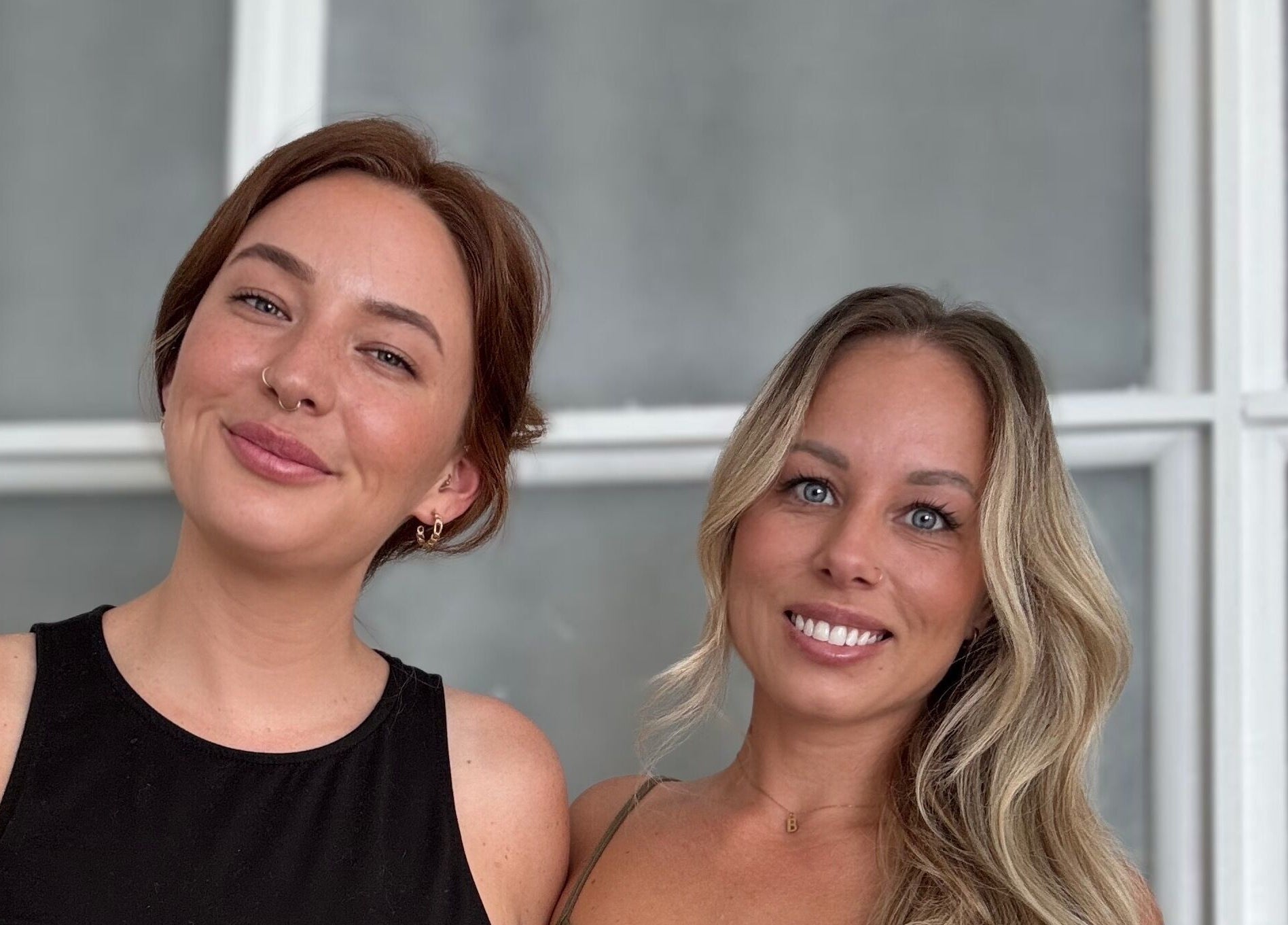 Two smiling women at Cyr Aesthetics in Petawawa, Ontario, CA, showcasing natural beauty and ambiance.