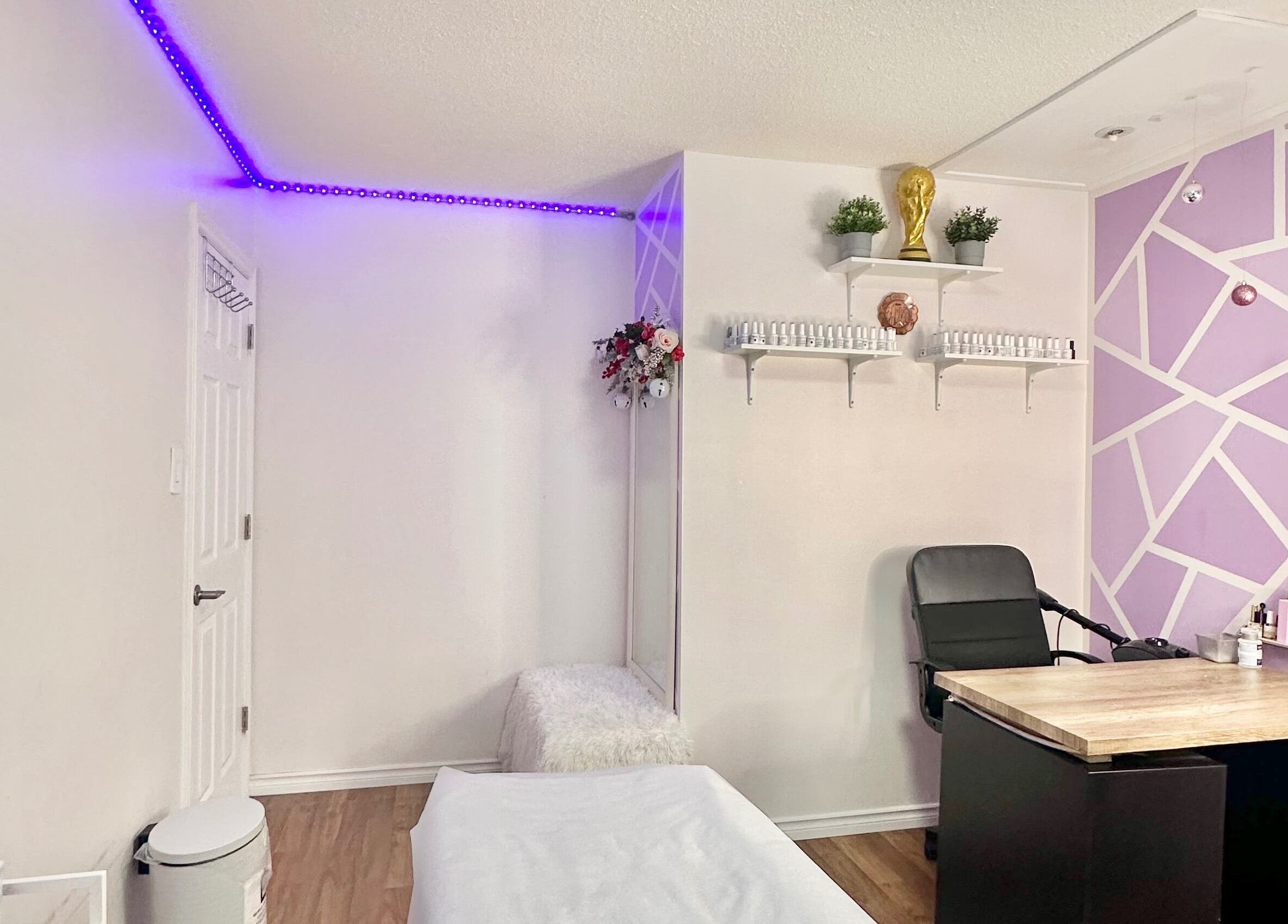 Modern beauty room at Exotic Touch, Barrie, Ontario, CA with purple accents and sleek furnishings.
