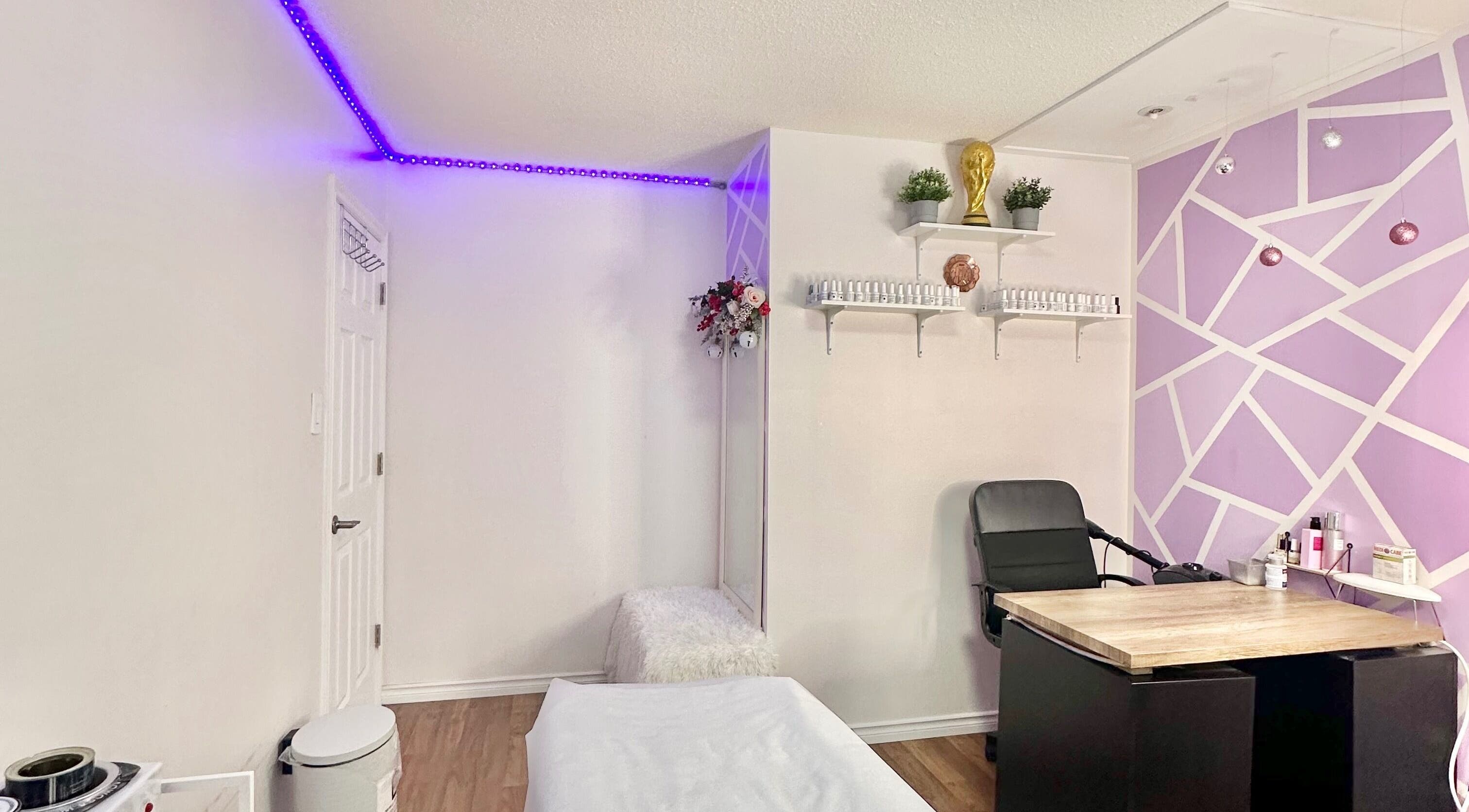 Modern beauty room at Exotic Touch, Barrie, Ontario, CA with purple accents and sleek furnishings.