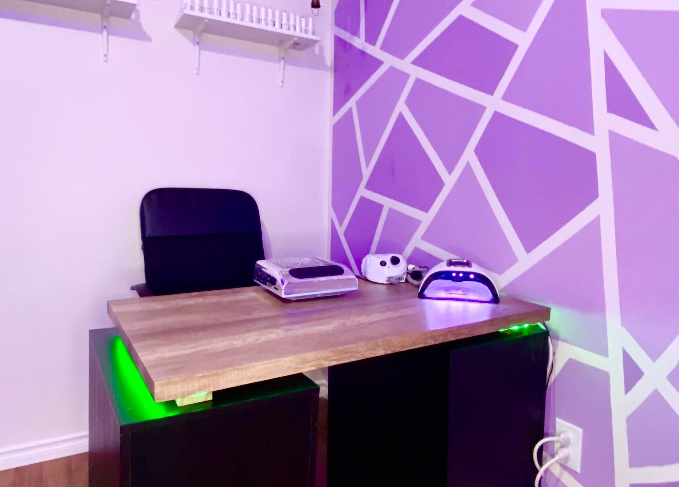 Nail station at Exotic Touch in Barrie, Ontario, CA with purple geometric wall design and manicure tools.