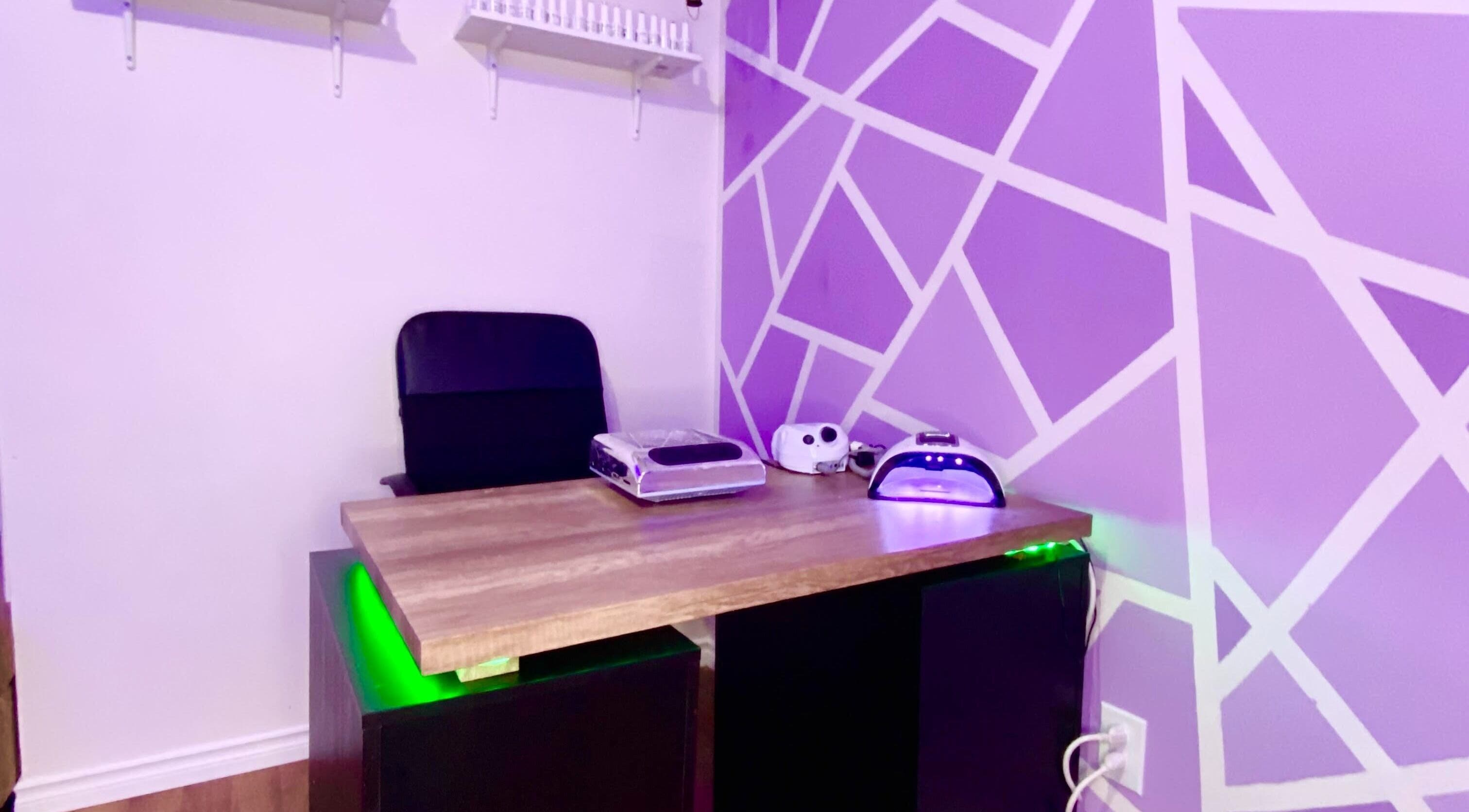 Nail station at Exotic Touch in Barrie, Ontario, CA with purple geometric wall design and manicure tools.