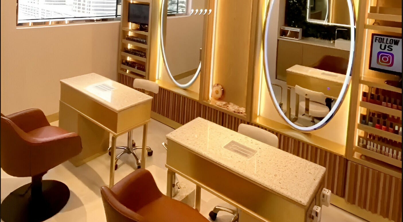 Stylish nail studio at Le Michel Salons Palm Jumeirah, Dubai, Dubai, AE with plush seating and elegant decor.