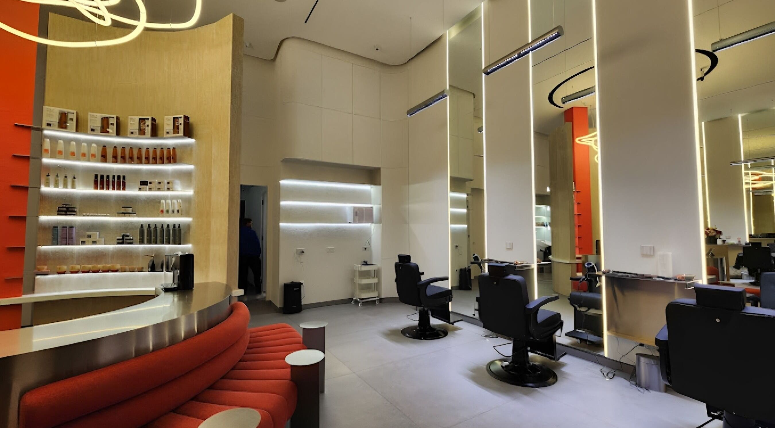 Modern salon interior at DOUQ | دوق, Amman, Amman Governorate, JO with stylish seating and product shelves.