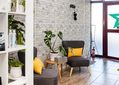 Cozy seating area at Nails by Nashy, Cape Town, Western Cape, ZA with stylish decor and plants.