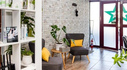 Cozy seating area at Nails by Nashy, Cape Town, Western Cape, ZA with stylish decor and plants.